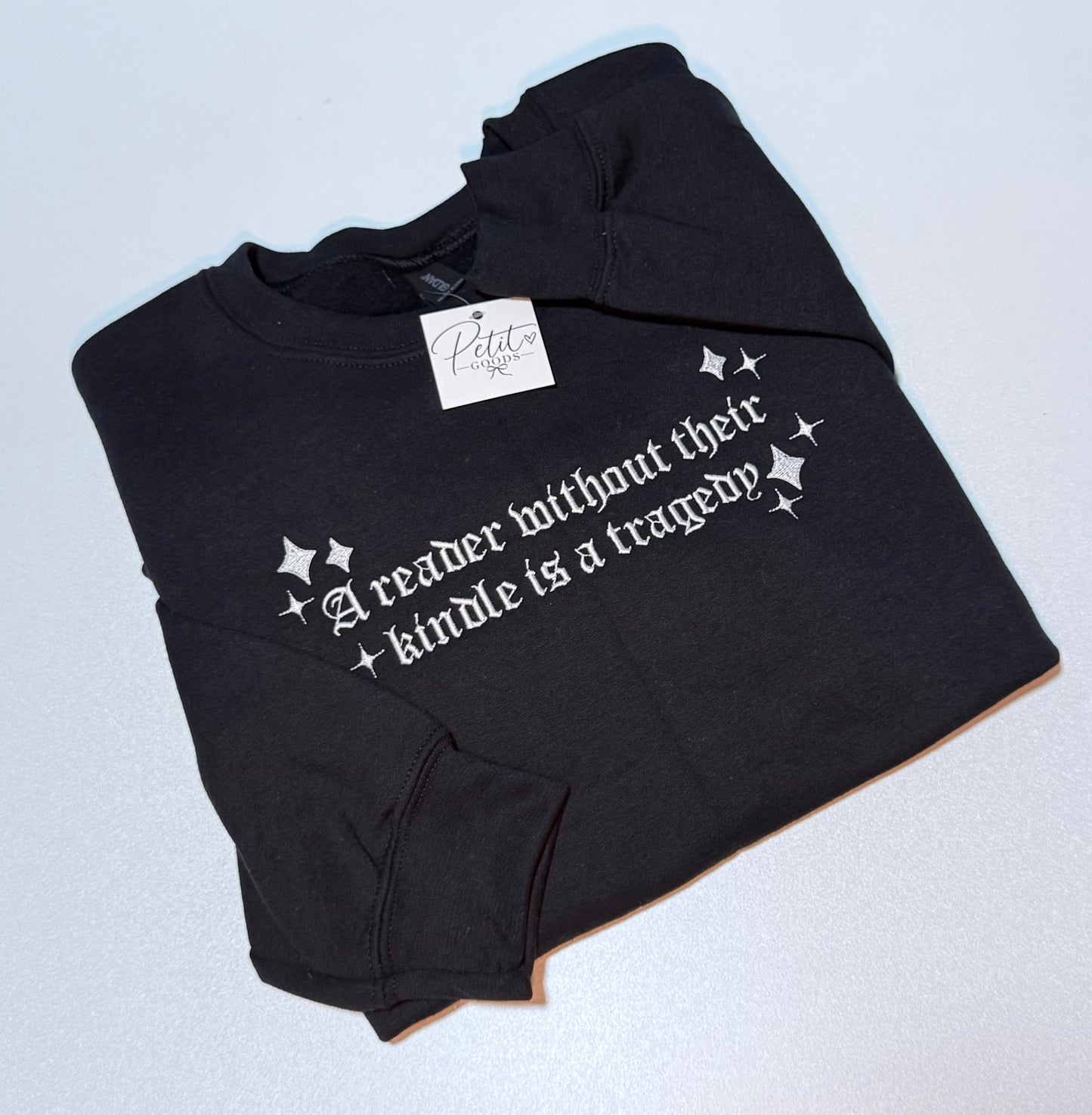 Black embroidered sweatshirt with kindle quote