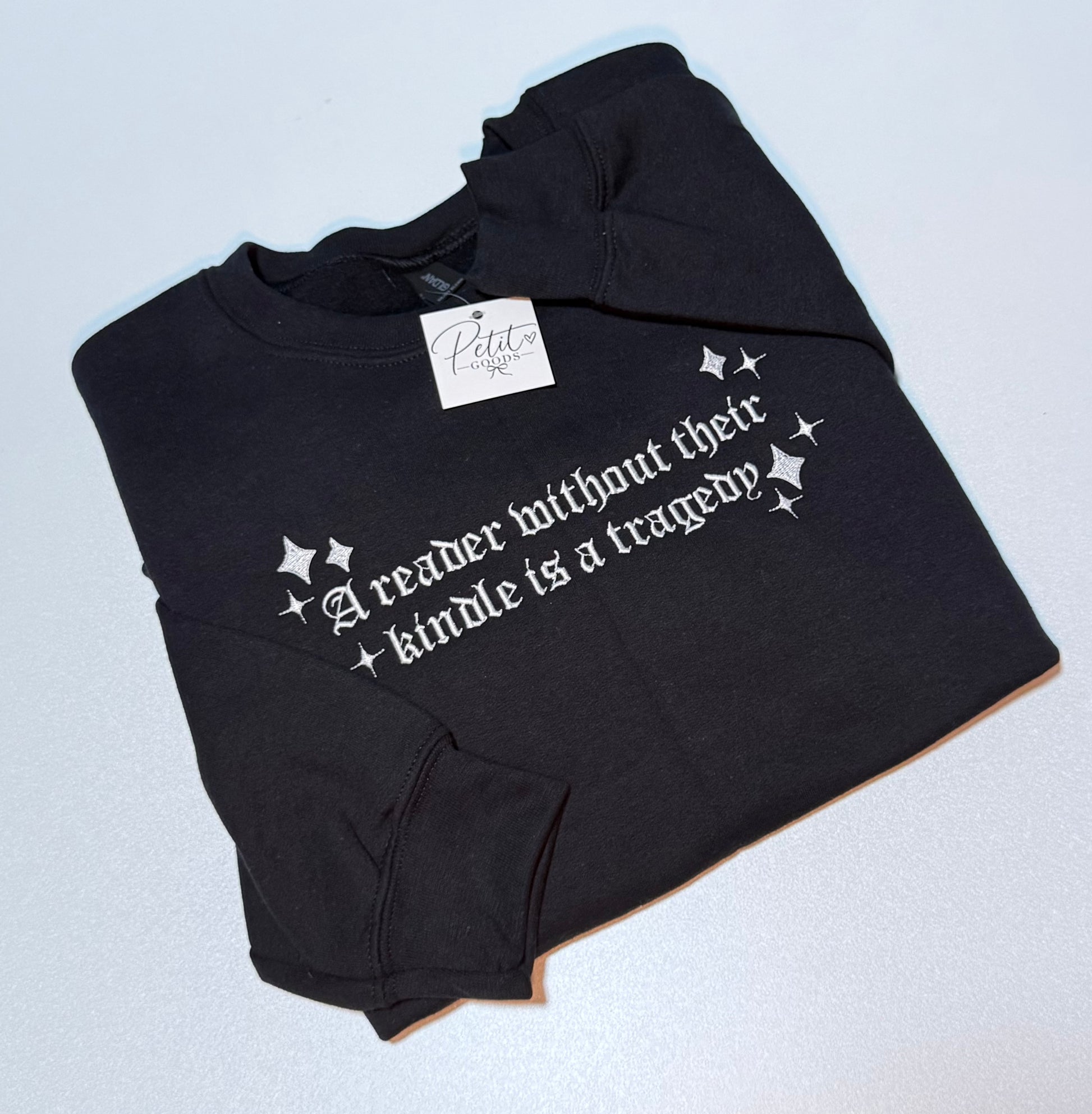 Black embroidered sweatshirt with kindle quote