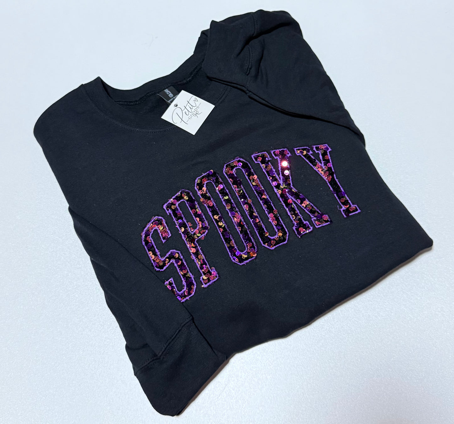 Black embroidered sweatshirt with Spooky sequin lettering