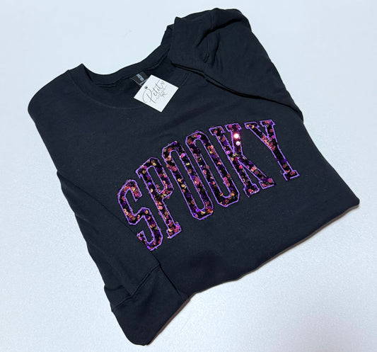 Black embroidered sweatshirt with Spooky sequin lettering