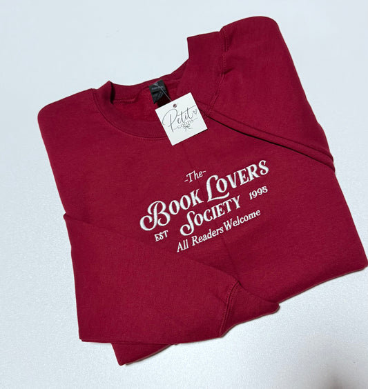 Red embroidered sweatshirt with Book Lovers Society design