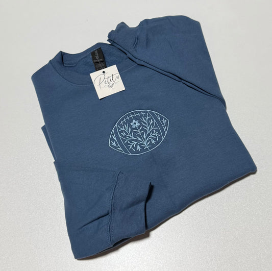 Blue embroidered sweatshirt with floral football design