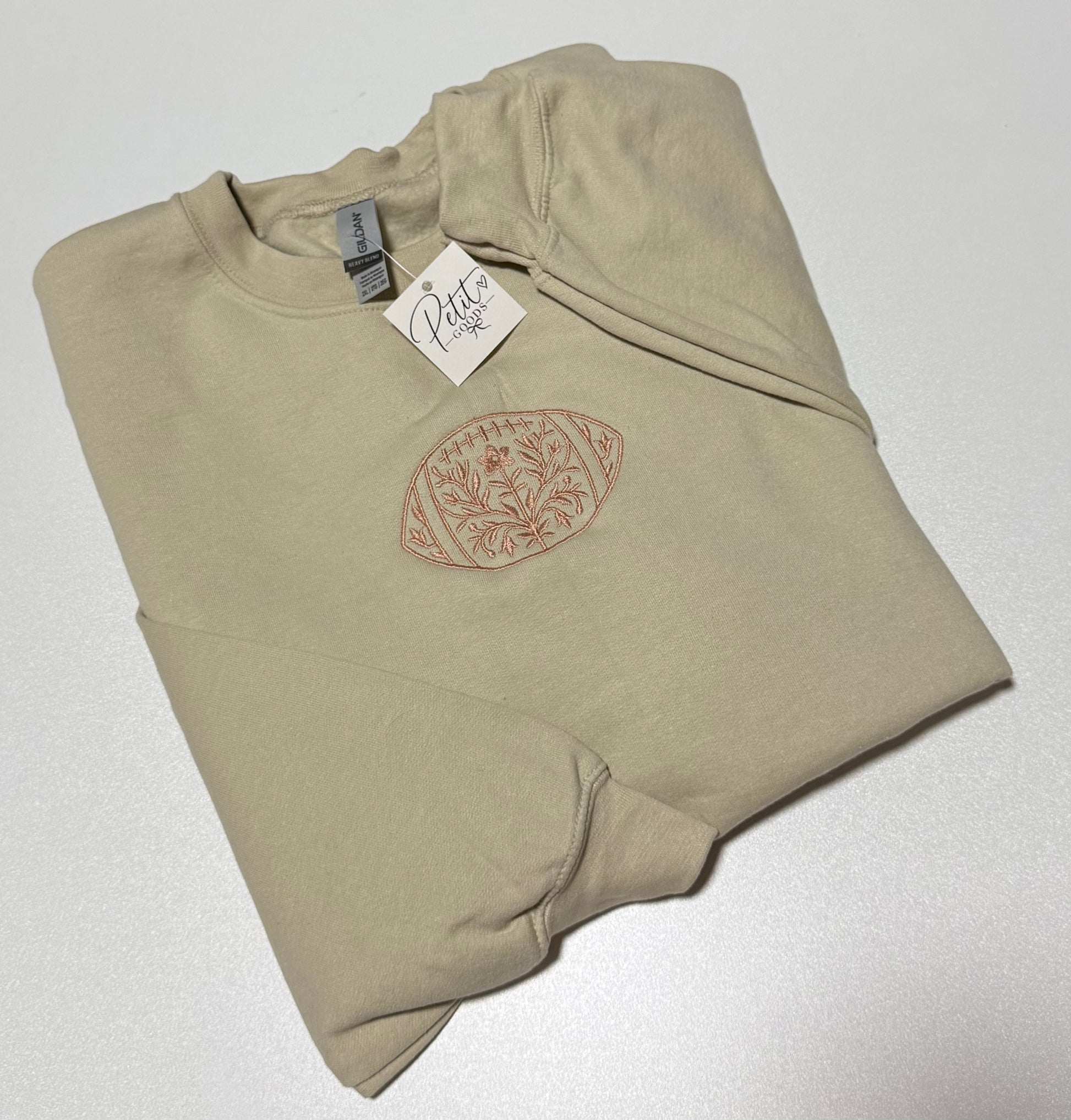 Beige embroidered sweatshirt with floral football design