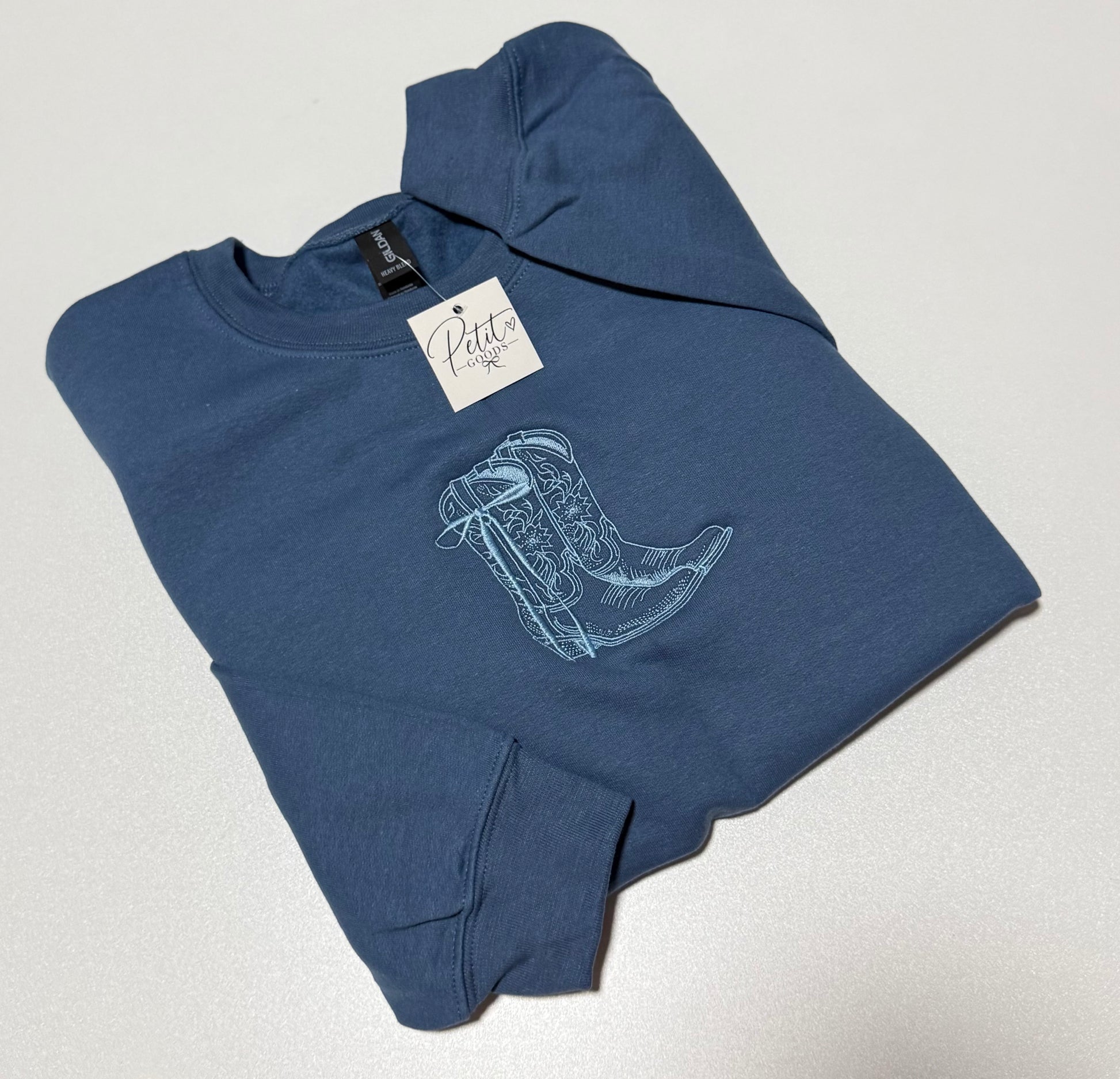 Blue embroidered sweatshirt with outline cowboy boots design